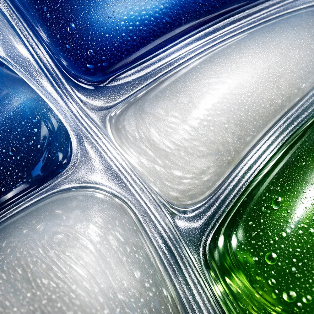 Extreme macro of a detergent pod showing the internal boundaries between separate chambers. High-contrast lighting highlights the textures of the different colored liquids. Technical engineering focus, 8k resolution, sterile lab aesthetic.