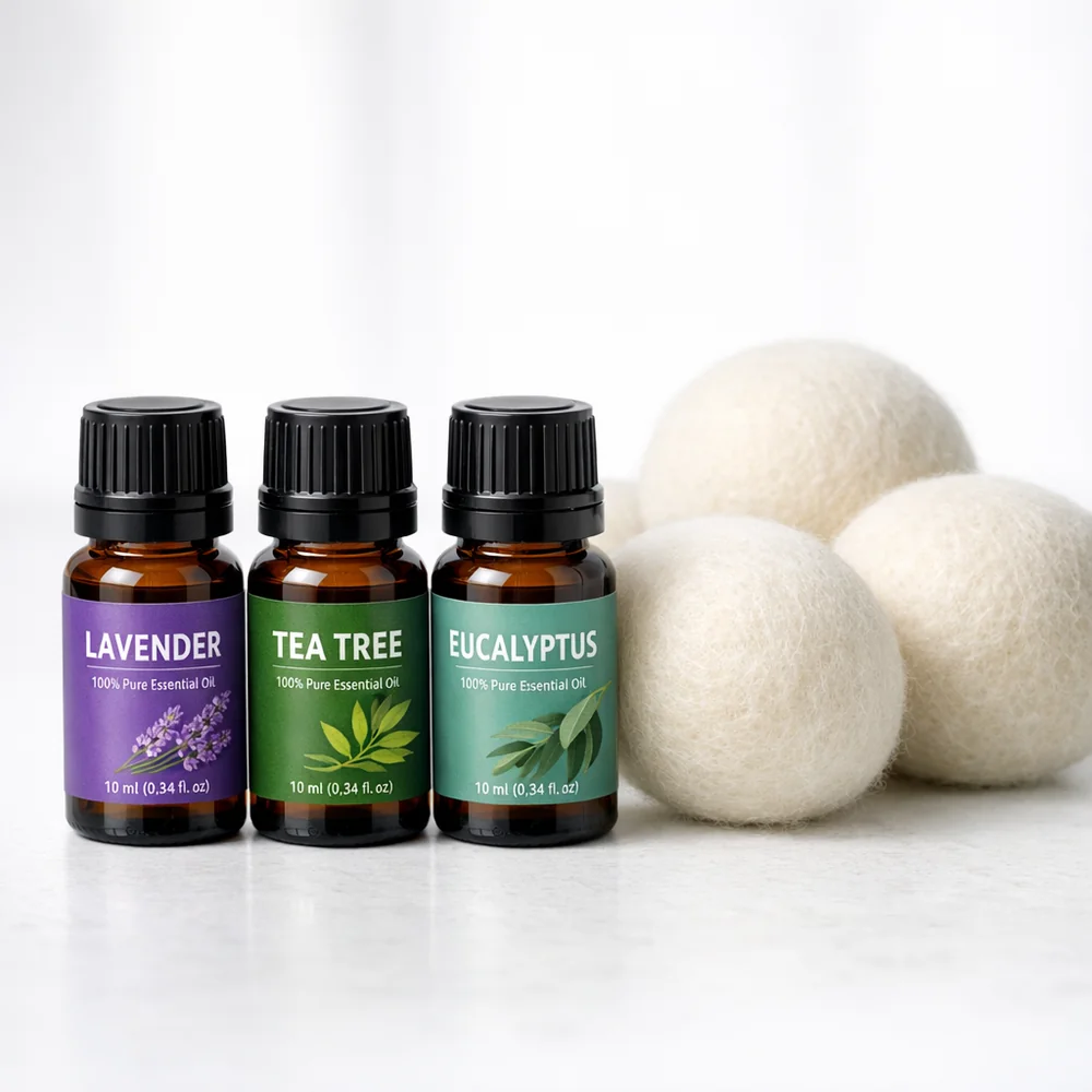 Professional arrangement of essential oil bottles (Lavender, Tea Tree, Eucalyptus) next to three wool dryer balls. Soft technical lighting, clinical background, 8k resolution.