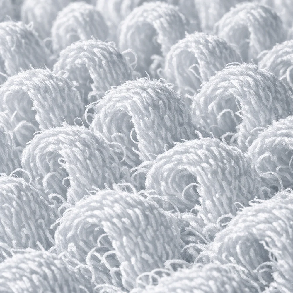 Extreme macro photograph of cotton 'Terry Loops'. Shows the high surface-area architecture designed for maximum capillary absorbency. High-contrast clinical lighting, hospital-grade aesthetic, 8k resolution, photorealistic fabric texture.